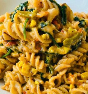 Colorful Vegan Rasta Pasta with bell pepper, ackee, spinach, coconut milk, and more