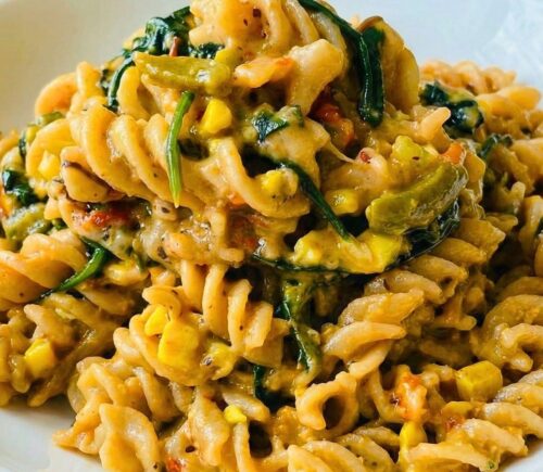Colorful Vegan Rasta Pasta with bell pepper, ackee, spinach, coconut milk, and more