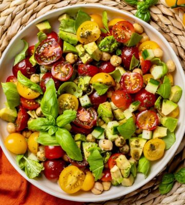 Fresh Cherry Tomato And Chickpea Salad with cucumber, avocado, basil, and lemon