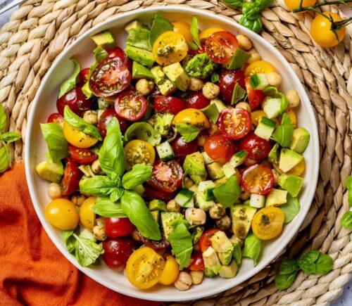 Fresh Cherry Tomato And Chickpea Salad with cucumber, avocado, basil, and lemon