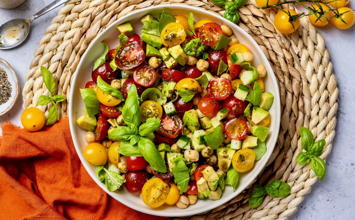 Fresh Cherry Tomato And Chickpea Salad with cucumber, avocado, basil, and lemon