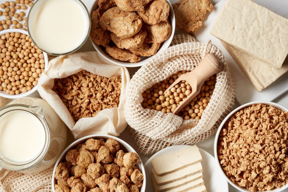 Photo shows a selection of alternative proteins, including non-dairy milk, soy beans, tofu, and more