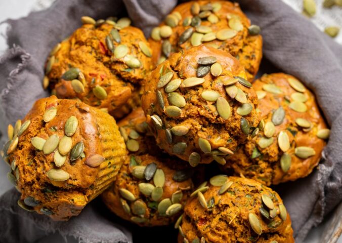 Savory Eggy Breakfast Muffins with flax, nutritional yeast, chickpea flour, corn, and pumpkin seeds on top
