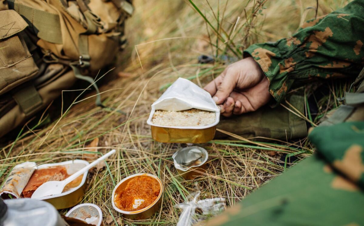 Photo shows soldiers sharing military rations on a small stove. The US Army is looking for new alternative proteins and plant-based meat products to put in soldiers' rations