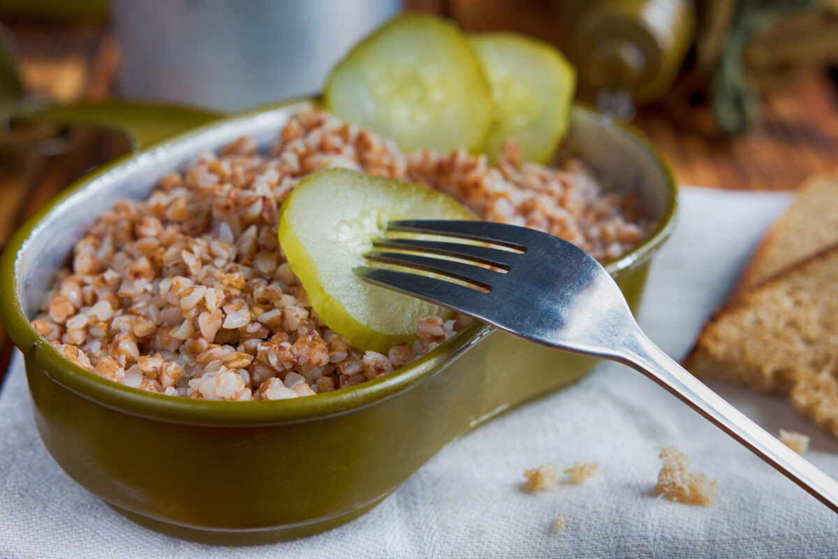 Photo shows an open army ration tin full of grain and topped with pickles. The US Army is looking for new alternative proteins and plant-based meat products to put in soldiers' rations
