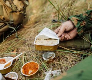 Photo shows soldiers sharing military rations on a small stove. The US Army is looking for new alternative proteins and plant-based meat products to put in soldiers' rations