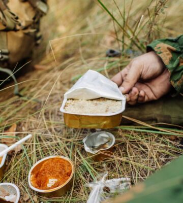 Photo shows soldiers sharing military rations on a small stove. The US Army is looking for new alternative proteins and plant-based meat products to put in soldiers' rations