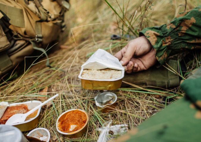 Photo shows soldiers sharing military rations on a small stove. The US Army is looking for new alternative proteins and plant-based meat products to put in soldiers' rations