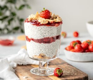 Strawberry Cheesecake Chia Pudding with coconut milk, cashews, vanilla, digestives, and strawberry compote