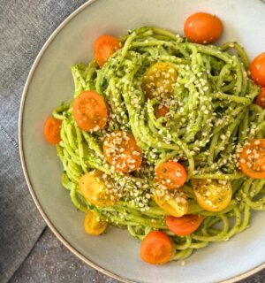 wild garlic and edamame pesto pasta with cherry tomatoes and hemp hearts