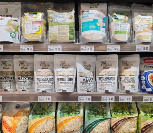 Organic superfoods displayed on a supermarket shelf to illustrate foods linked to tripling fiber intake