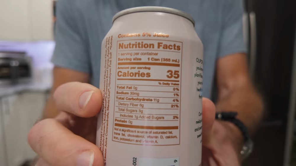 Thomson holds up can to show its nutrition information, to illustrate article about his 30-day challenge focused on tripling fiber intake