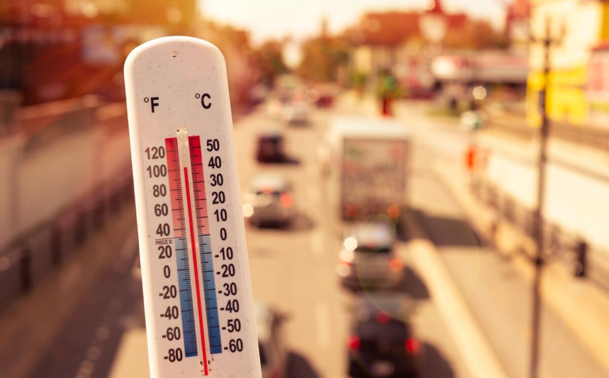 Photo shows a thermometer in someone's hand on an overpass above a busy road. Temperatures in the UK could hit 40C this week for the second time since records began, and animal agriculture is responsible