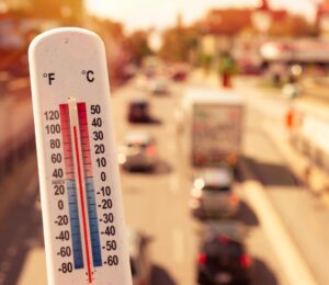Photo shows a thermometer in someone's hand on an overpass above a busy road. Temperatures in the UK could hit 40C this week for the second time since records began, and animal agriculture is responsible