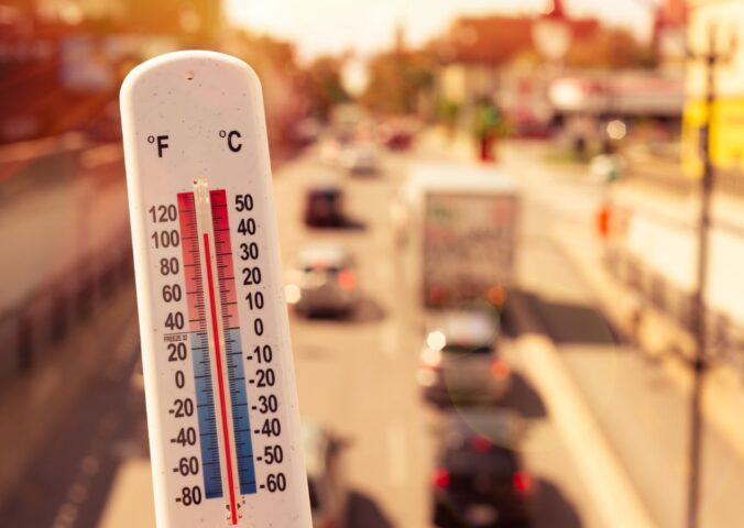 Photo shows a thermometer in someone's hand on an overpass above a busy road. Temperatures in the UK could hit 40C this week for the second time since records began, and animal agriculture is responsible