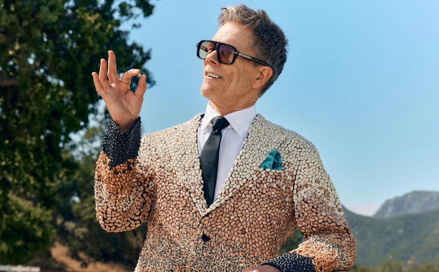 Photo shows Kevin Bacon holding up a single bean. Kevin Bacon has suggested swapping meat for beans on a Wednesday to improve your health, harm fewer animals, and protect the planet