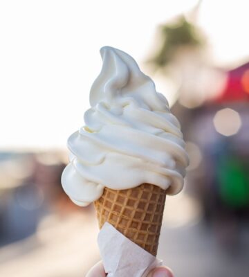 Photo shows someone's hand holding up a soft serve ice cream cone. A Legoland customer has said that a server at the park advised them that all of the soft serve ice cream is now made using a vegan mix from Flora
