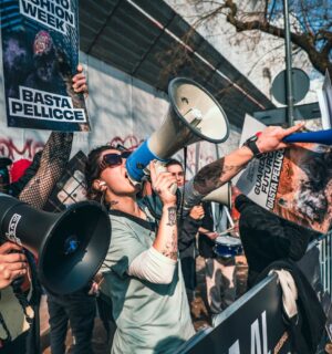 Photo shows CAFT protestors. CAFT has been protesting Milan Fashion Week's continued use of fur on the runway. The Lutech Group is the fifth and most recent company to drop its partnership with Milan Fashion Week over the issue.