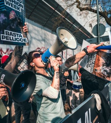Photo shows CAFT protestors. CAFT has been protesting Milan Fashion Week's continued use of fur on the runway. The Lutech Group is the fifth and most recent company to drop its partnership with Milan Fashion Week over the issue.
