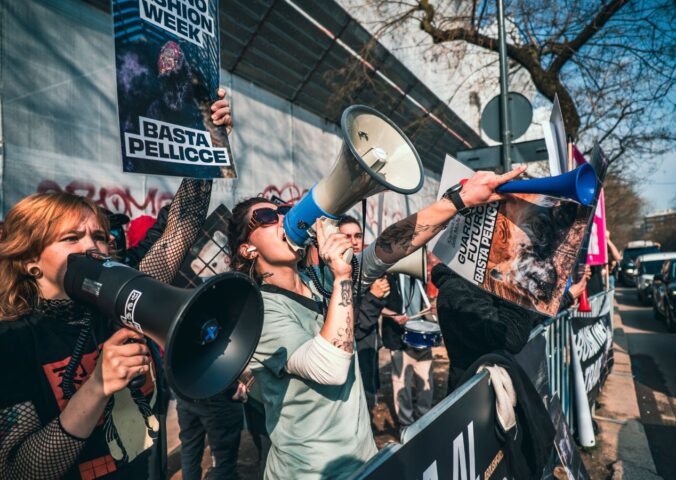 Photo shows CAFT protestors. CAFT has been protesting Milan Fashion Week's continued use of fur on the runway. The Lutech Group is the fifth and most recent company to drop its partnership with Milan Fashion Week over the issue.