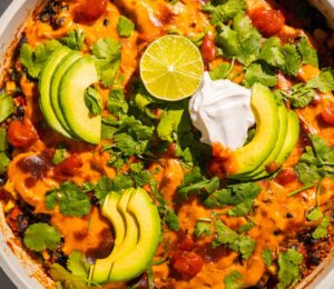 One-Pan Vegan Taco Skillet with avocado, lime, tortilla chips, vegan cheese, black beans and quinoa
