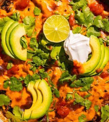 One-Pan Vegan Taco Skillet with avocado, lime, tortilla chips, vegan cheese, black beans and quinoa