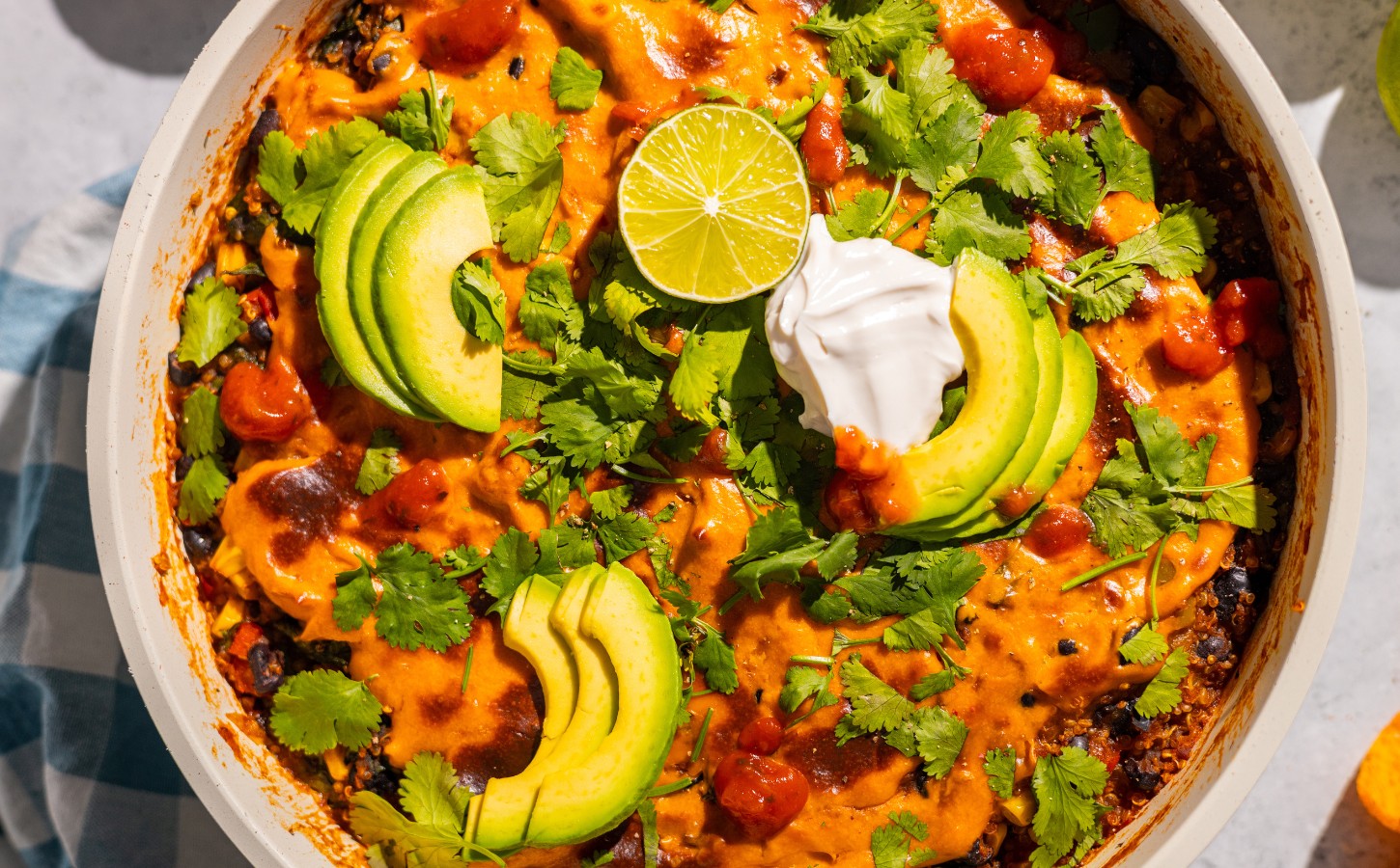 One-Pan Vegan Taco Skillet with avocado, lime, tortilla chips, vegan cheese, black beans and quinoa