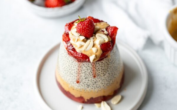 Peanut Butter Jelly Chia Pudding with almond milk, strawberry jam, and chopped peanuts