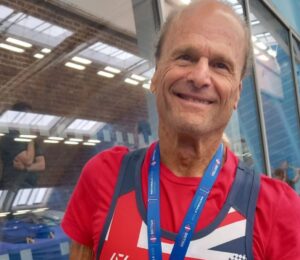 Photo shows Dr Doug Graham, a raw vegan fitness coach and champion powerlifter, wearing a medal from a recent event.