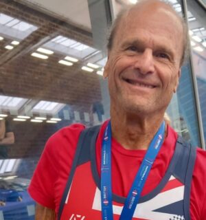 Photo shows Dr Doug Graham, a raw vegan fitness coach and champion powerlifter, wearing a medal from a recent event.