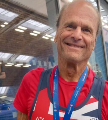 Photo shows Dr Doug Graham, a raw vegan fitness coach and champion powerlifter, wearing a medal from a recent event.