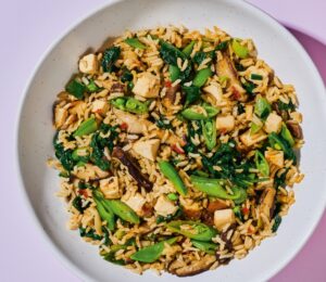 Shiitake And Smoked Tofu Fried Rice with chili bean paste, smoked tofu, baby spinach, ands snap peas