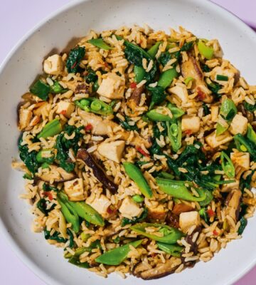 Shiitake And Smoked Tofu Fried Rice with chili bean paste, smoked tofu, baby spinach, ands snap peas