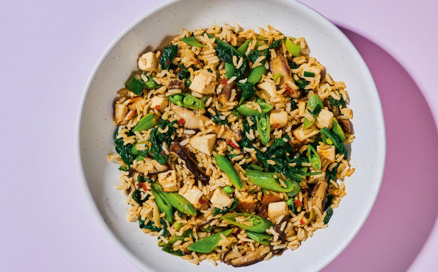 Shiitake And Smoked Tofu Fried Rice with chili bean paste, smoked tofu, baby spinach, ands snap peas