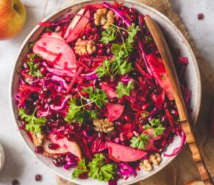 Superfood Apple Beet Salad with red cabbage, carrots, beetroot, walnuts, chia seeds, and parsley