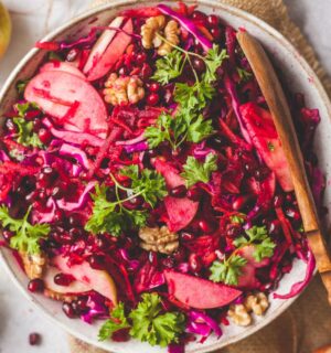Superfood Apple Beet Salad with red cabbage, carrots, beetroot, walnuts, chia seeds, and parsley