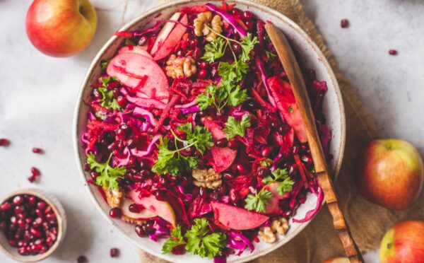 Superfood Apple Beet Salad with red cabbage, carrots, beetroot, walnuts, chia seeds, and parsley