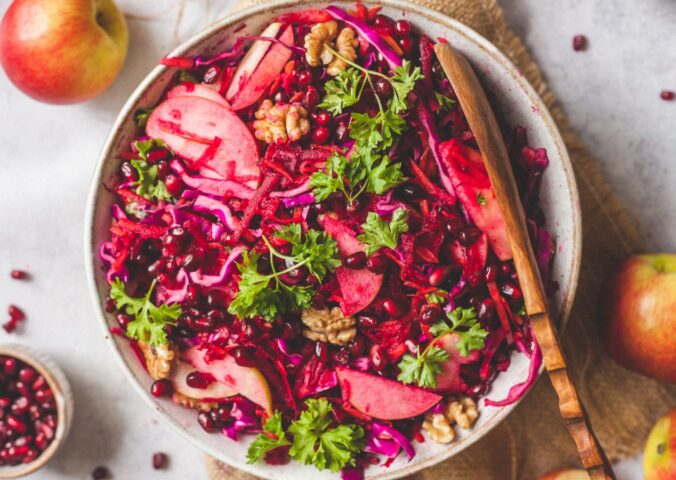 Superfood Apple Beet Salad with red cabbage, carrots, beetroot, walnuts, chia seeds, and parsley