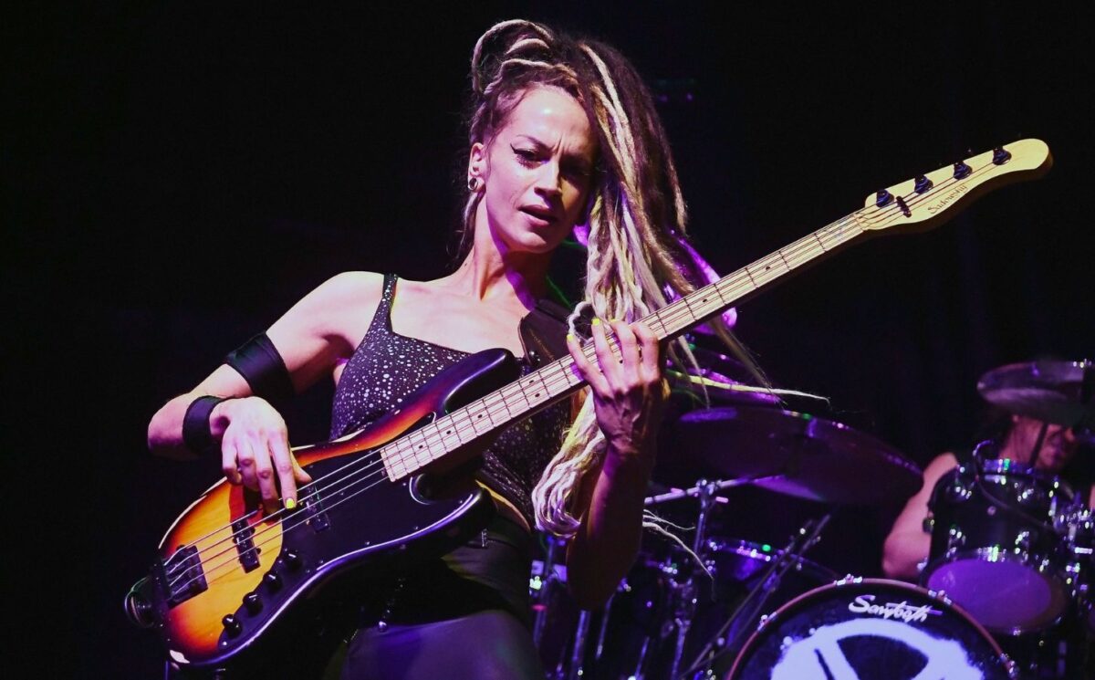 Photo shows vegan rock star Tanya O'Callaghan, who was recently interviewed by Plant Based News, playing bass onstage