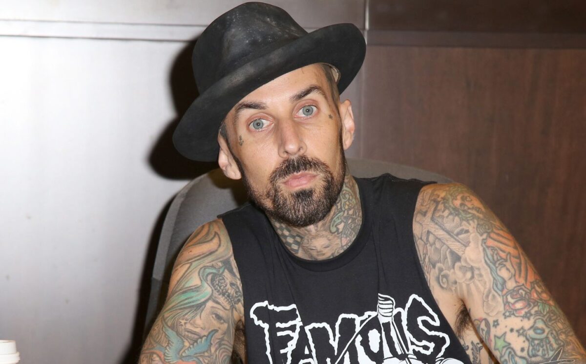 Photo shows Blink 182 drummer Travis Barker signing a book. Travis Barker has joined Mr Charlie’s, sometimes known as the “vegan McDonald’s,” as an equity partner and brand ambassador