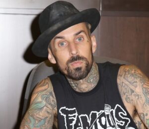 Photo shows Blink 182 drummer Travis Barker signing a book. Travis Barker has joined Mr Charlie’s, sometimes known as the “vegan McDonald’s,” as an equity partner and brand ambassador