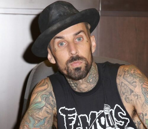 Photo shows Blink 182 drummer Travis Barker signing a book. Travis Barker has joined Mr Charlie’s, sometimes known as the “vegan McDonald’s,” as an equity partner and brand ambassador
