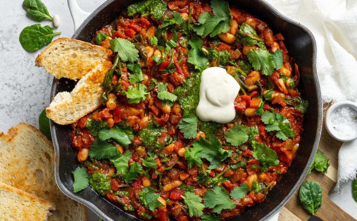 Vegan White Bean Shakshuka with cannellini beans, spinach, tomato paste, and red pepper