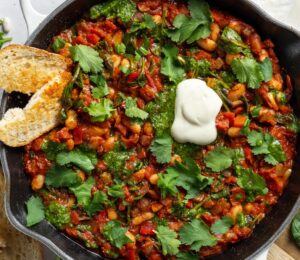 Vegan White Bean Shakshuka with cannellini beans, spinach, tomato paste, and red pepper