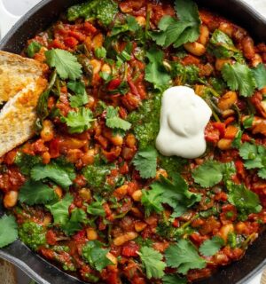 Vegan White Bean Shakshuka with cannellini beans, spinach, tomato paste, and red pepper