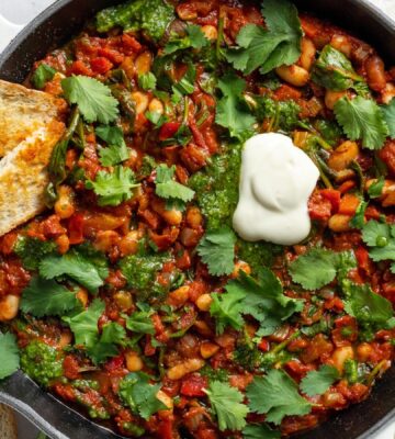 Vegan White Bean Shakshuka with cannellini beans, spinach, tomato paste, and red pepper