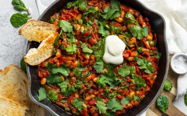 Vegan White Bean Shakshuka with cannellini beans, spinach, tomato paste, and red pepper