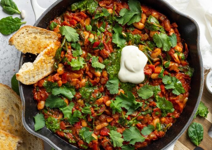 Vegan White Bean Shakshuka with cannellini beans, spinach, tomato paste, and red pepper