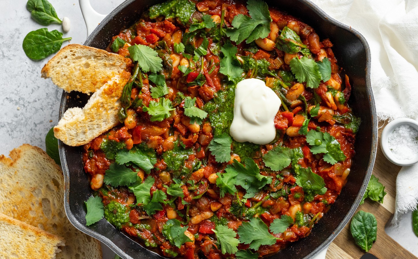 Vegan White Bean Shakshuka with cannellini beans, spinach, tomato paste, and red pepper