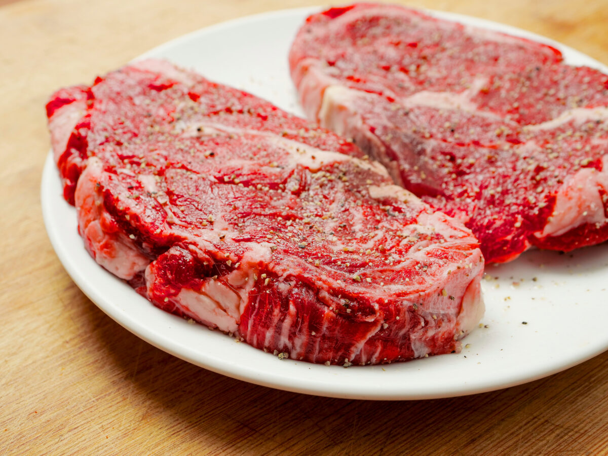 Photo shows two raw steaks on a white plate. Mikhaila Peterson has said that the first thing she fed her baby was meat. She fed her daughter “only meat” for several years after she began eating solid food